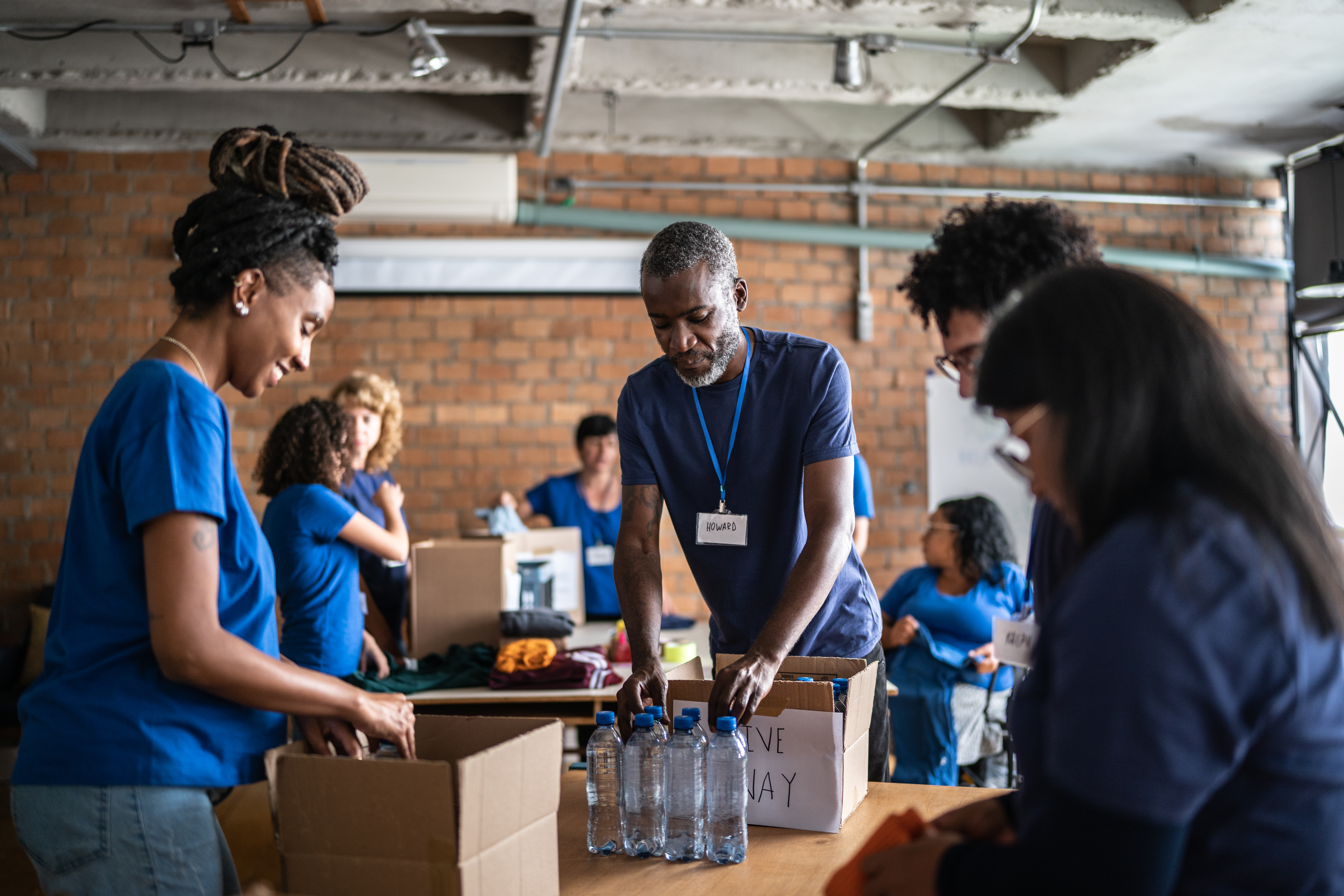 a group of volunteers organize supplies at a charity donation event